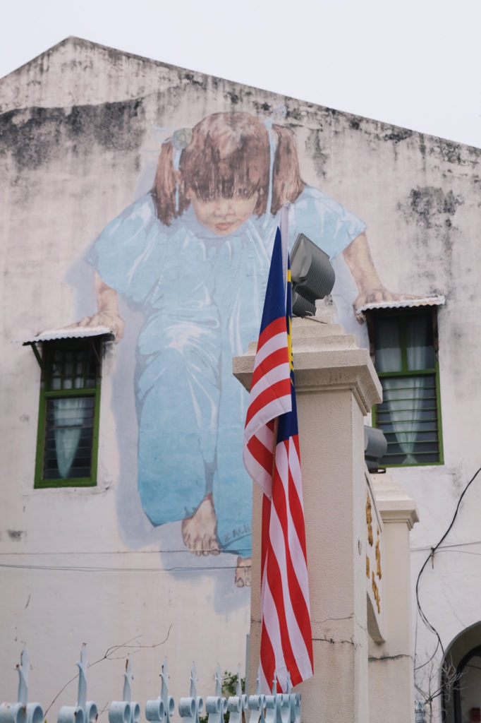 George Town street art girl window